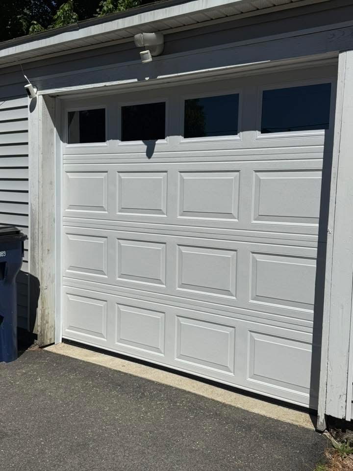 New white raised-panel garage door with windows installed by Nolin Overhead Doors