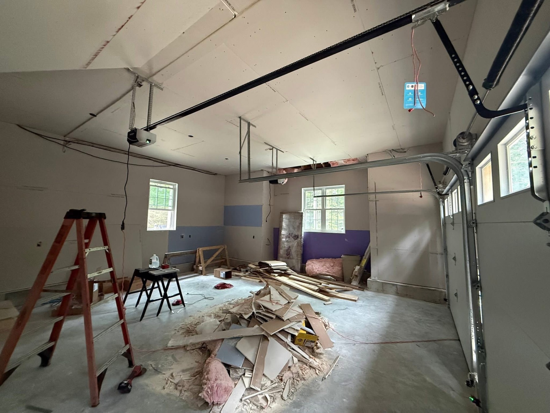 Garage interior during a door and opener installation project by Nolin Overhead Doors